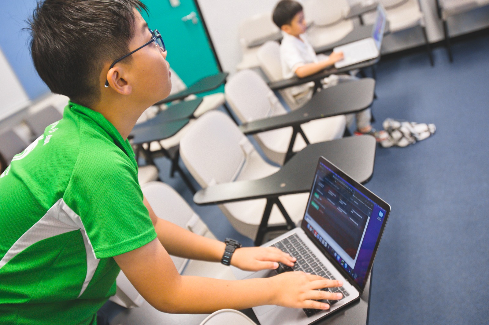Young students working on AI coding projects